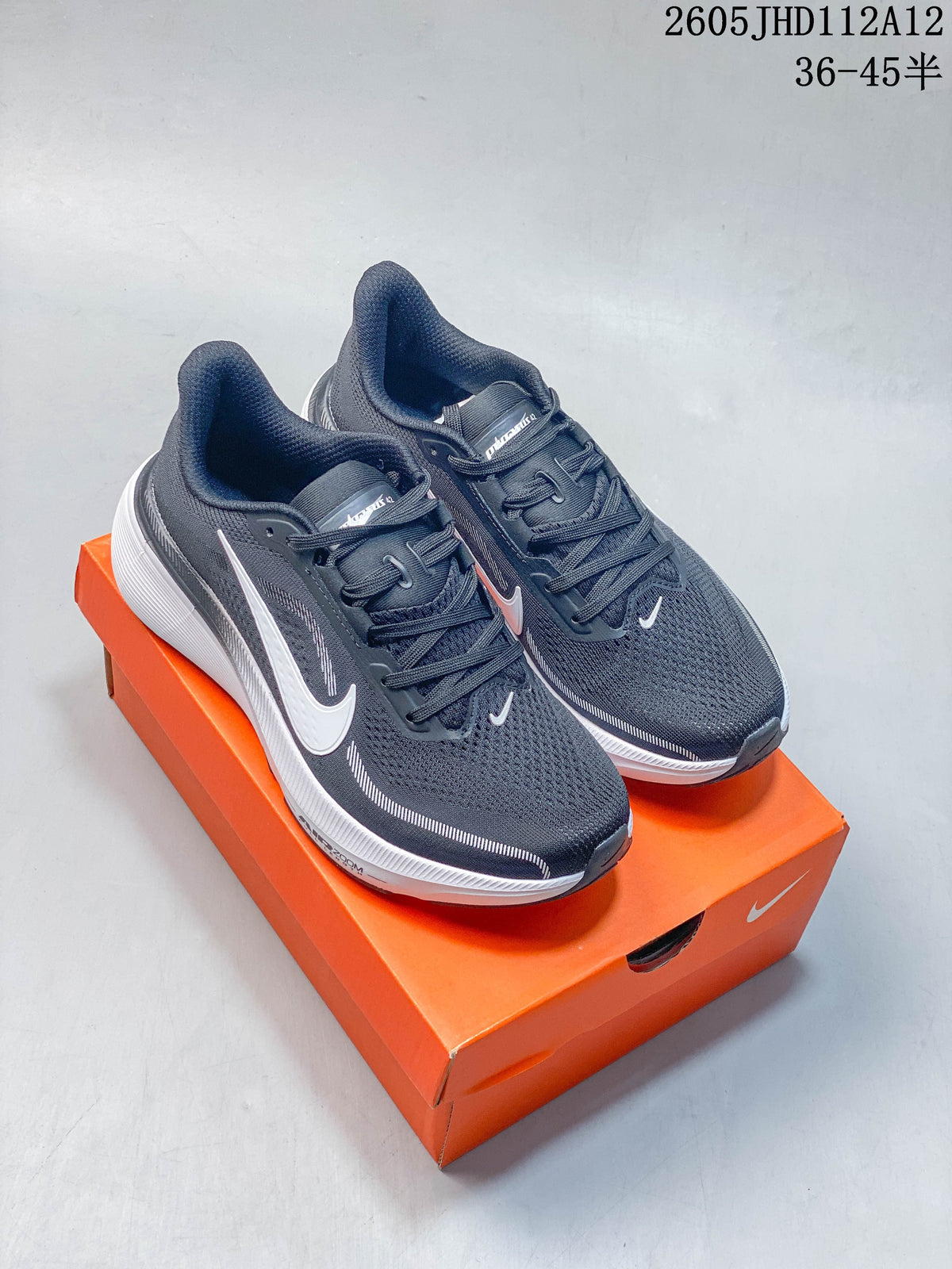 Pair of dark gray Nike Air Zoom Pegasus 42 shoes on an orange shoebox