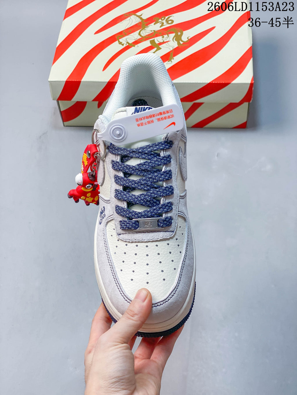 Top view showing the perforated toe, dark blue laces, and decorative red charm
