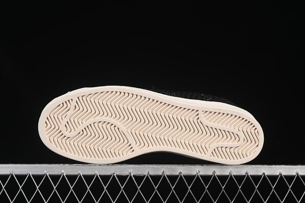 Underside view showing the patterned off-white outsoles