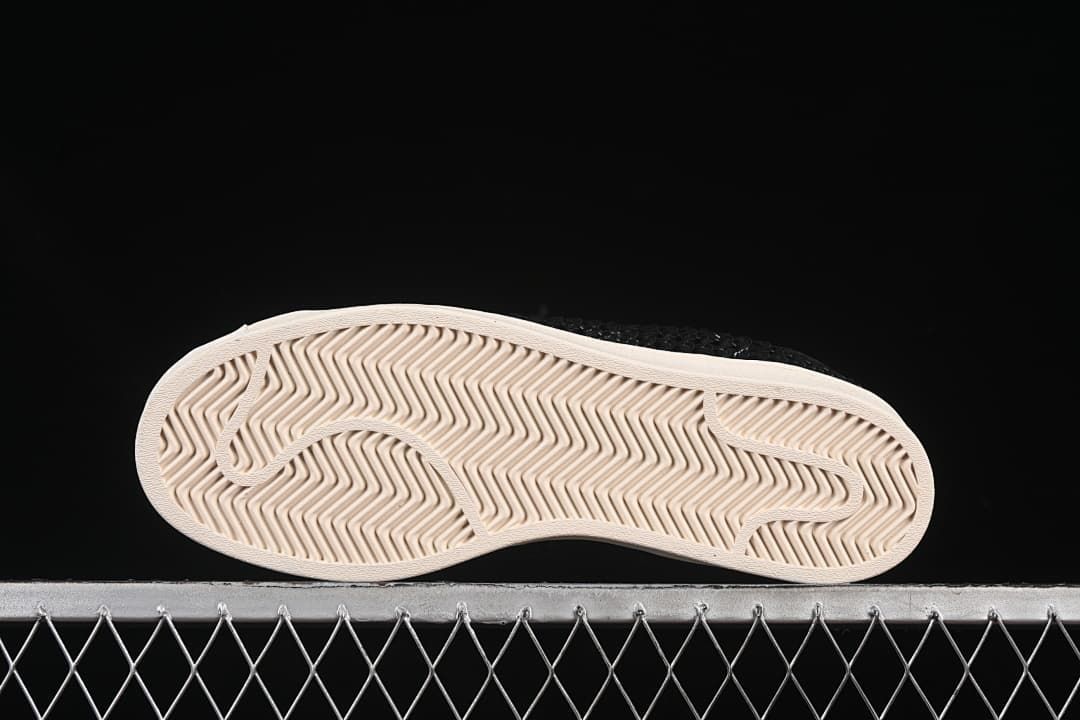 Underside view showing the patterned off-white outsoles