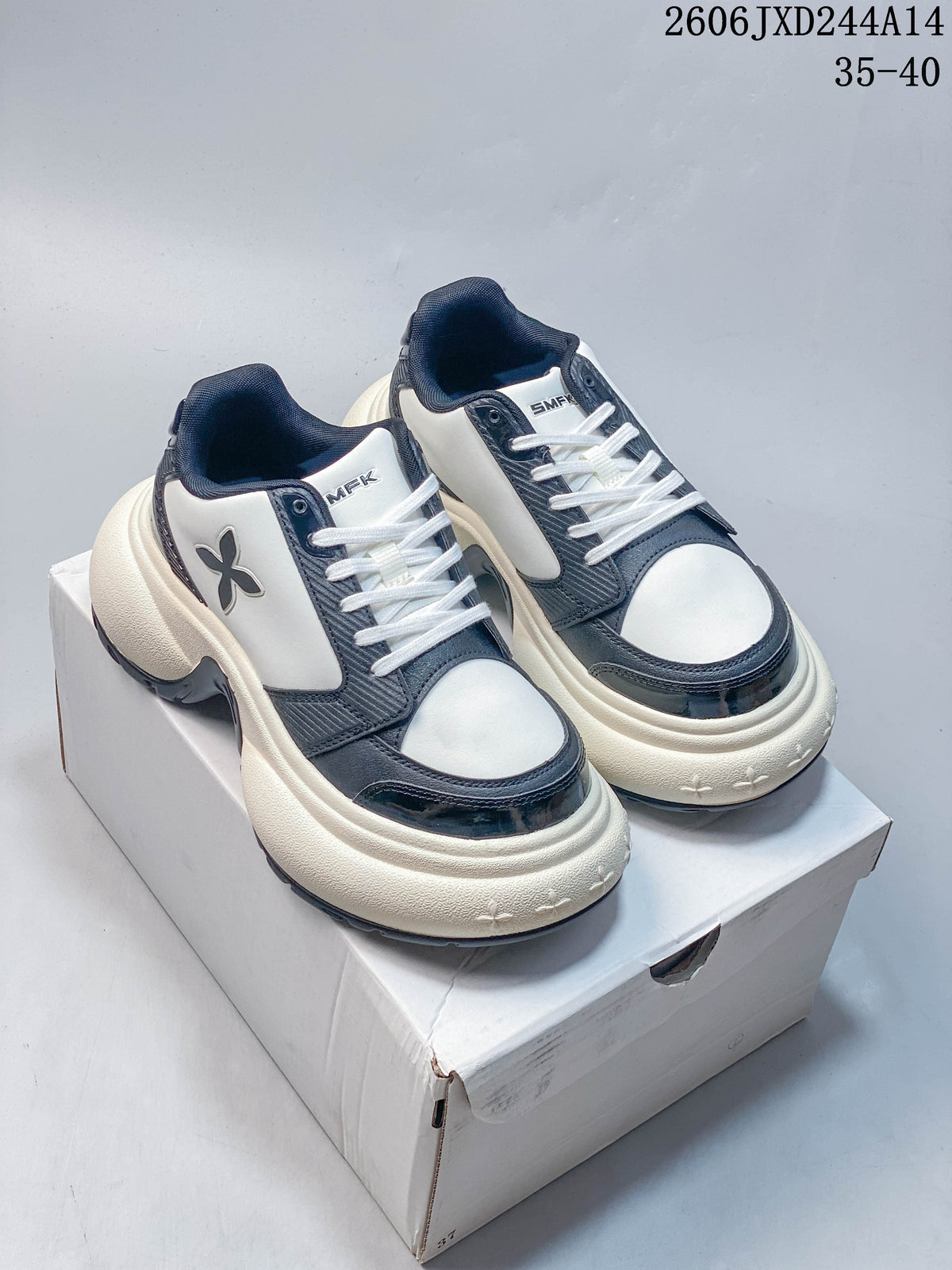Pair of white and navy SMFK sneakers with chunky cream-colored soles, shown on a box
