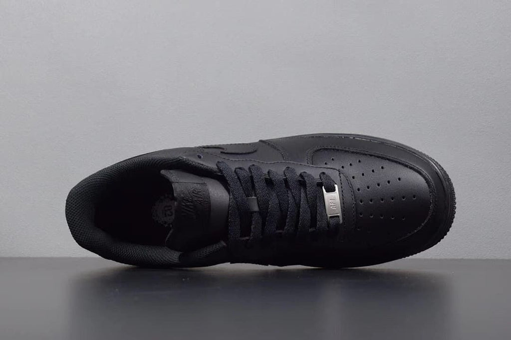 Overhead view of the black sneaker showing laces and perforated toe