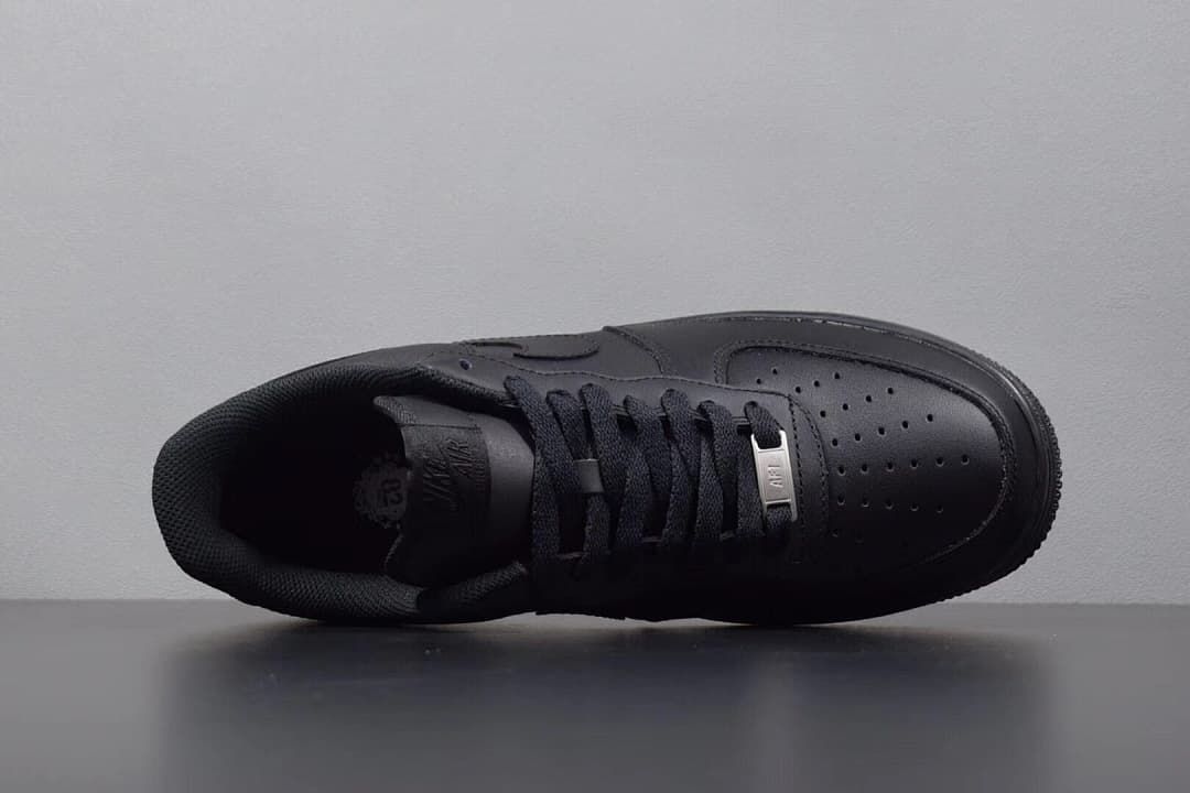 Overhead view of the black sneaker showing laces and perforated toe
