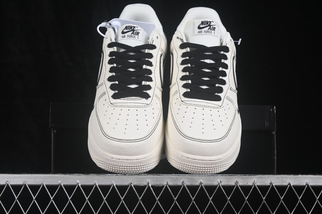 Front view of white and black Nike Air Force 1 '07 low-top sneakers with black laces.