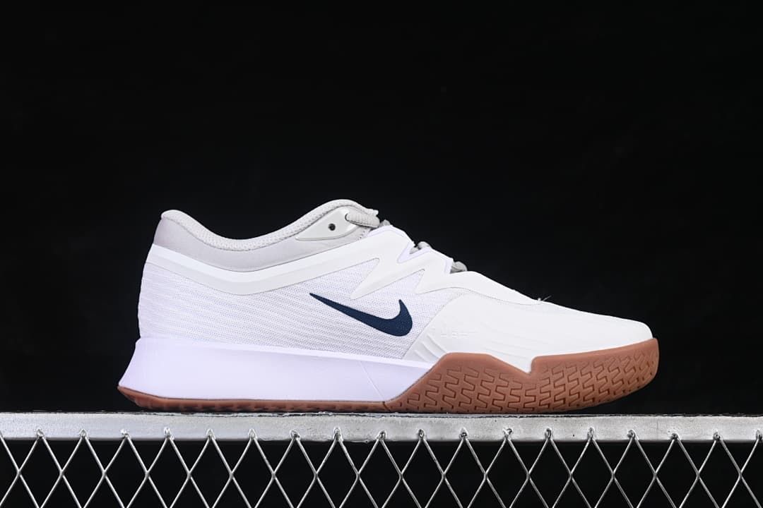 Side profile highlighting the mesh-look upper, navy Swoosh, and gum outsole.