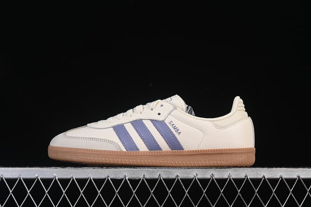 Side view of a cream adidas Samba OG sneaker with blue stripes and a gum-colored sole