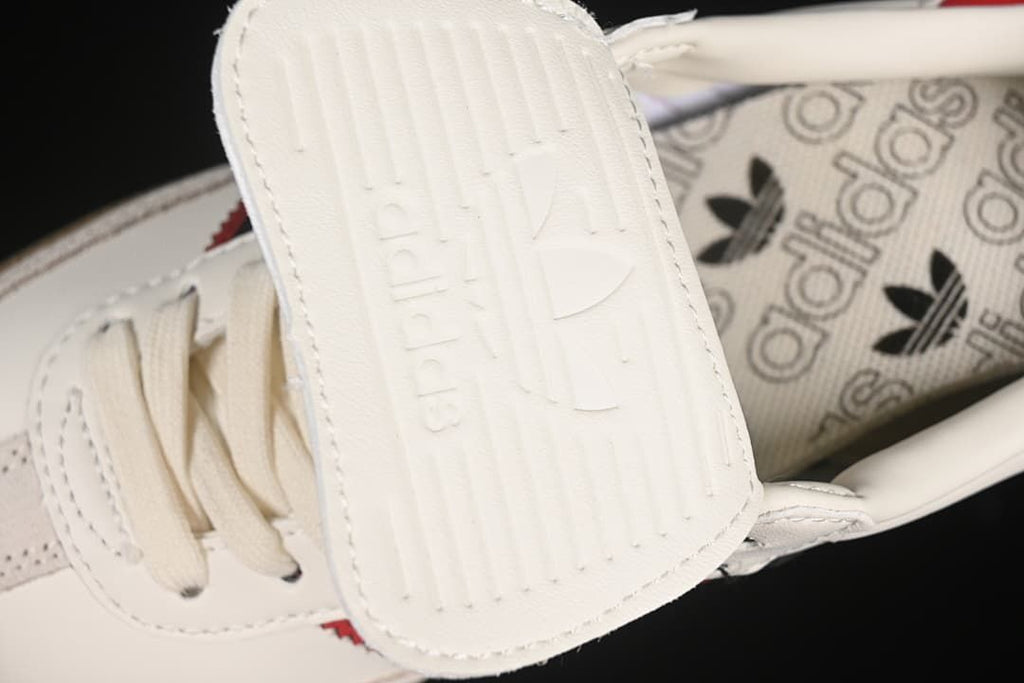 Close-up of the fold-over tongue with embossed adidas branding.