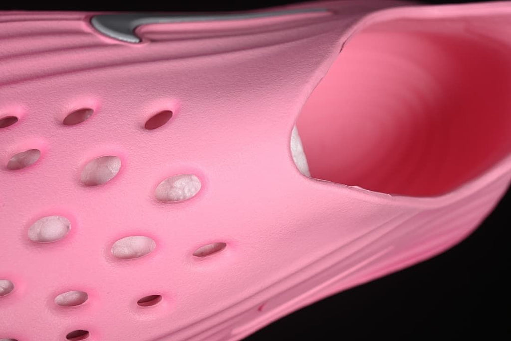 Close-up of the clog's perforated upper and open heel opening.