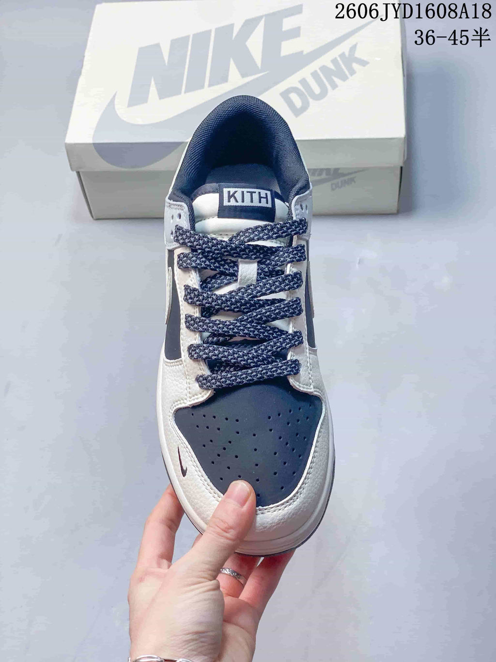 Top view of a low-top sneaker showing patterned laces and a perforated navy toe