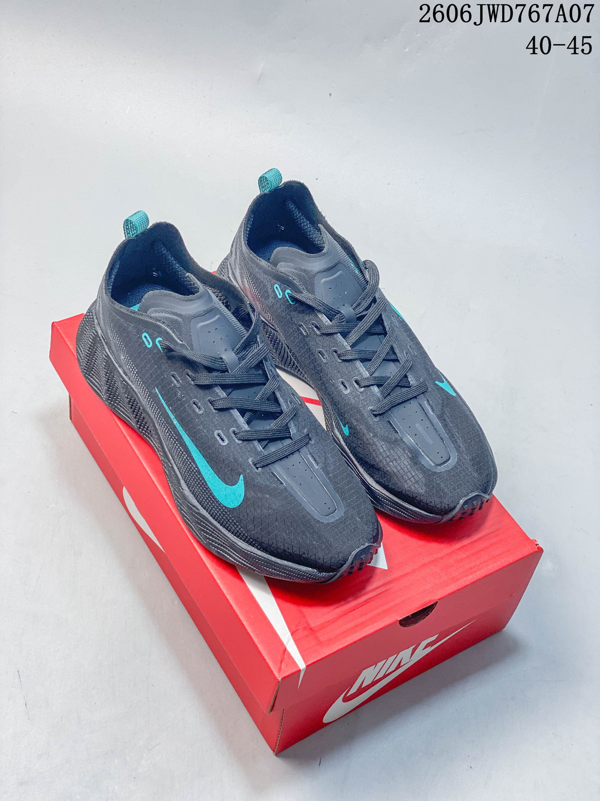 Pair of charcoal gray Nike Ava Rover low-top shoes with teal accents on a red shoebox