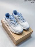 Pair of white and blue On Cloudvista 2 trail running shoes displayed on a box