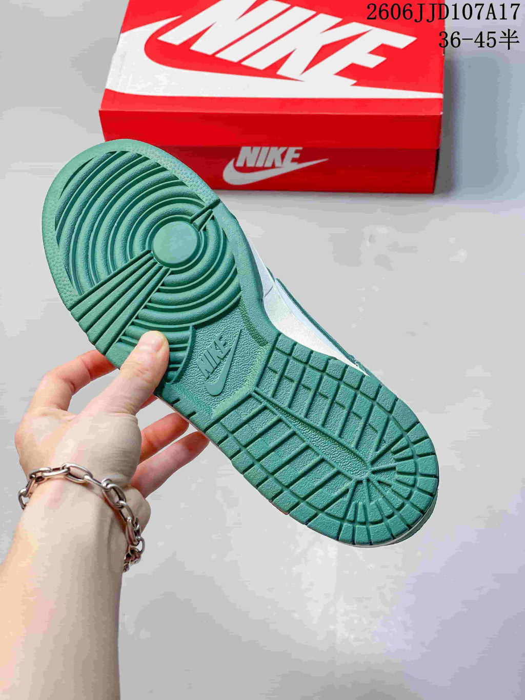 Green outsole with circular tread pattern on a low-top sneaker