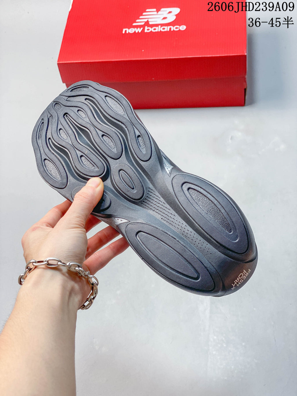 Underside of a gray New Balance shoe showing the sculpted sole