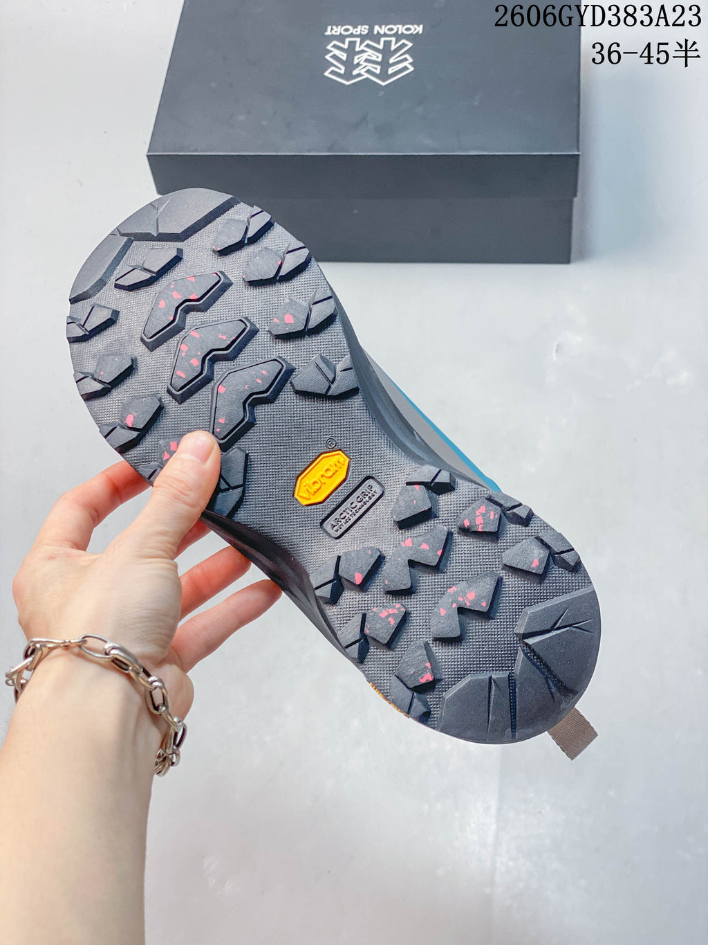 Close-up of the lugged outsole with Vibram markings
