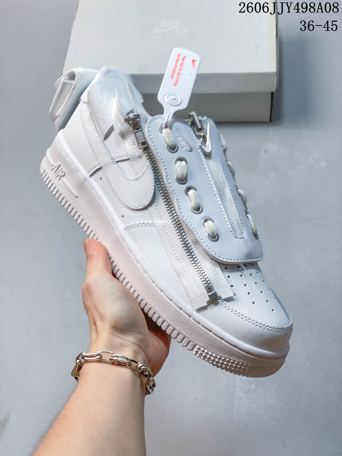 Angled side view of a white Nike Air Force 1 ’07 Low sneaker with a side zipper and Swoosh.