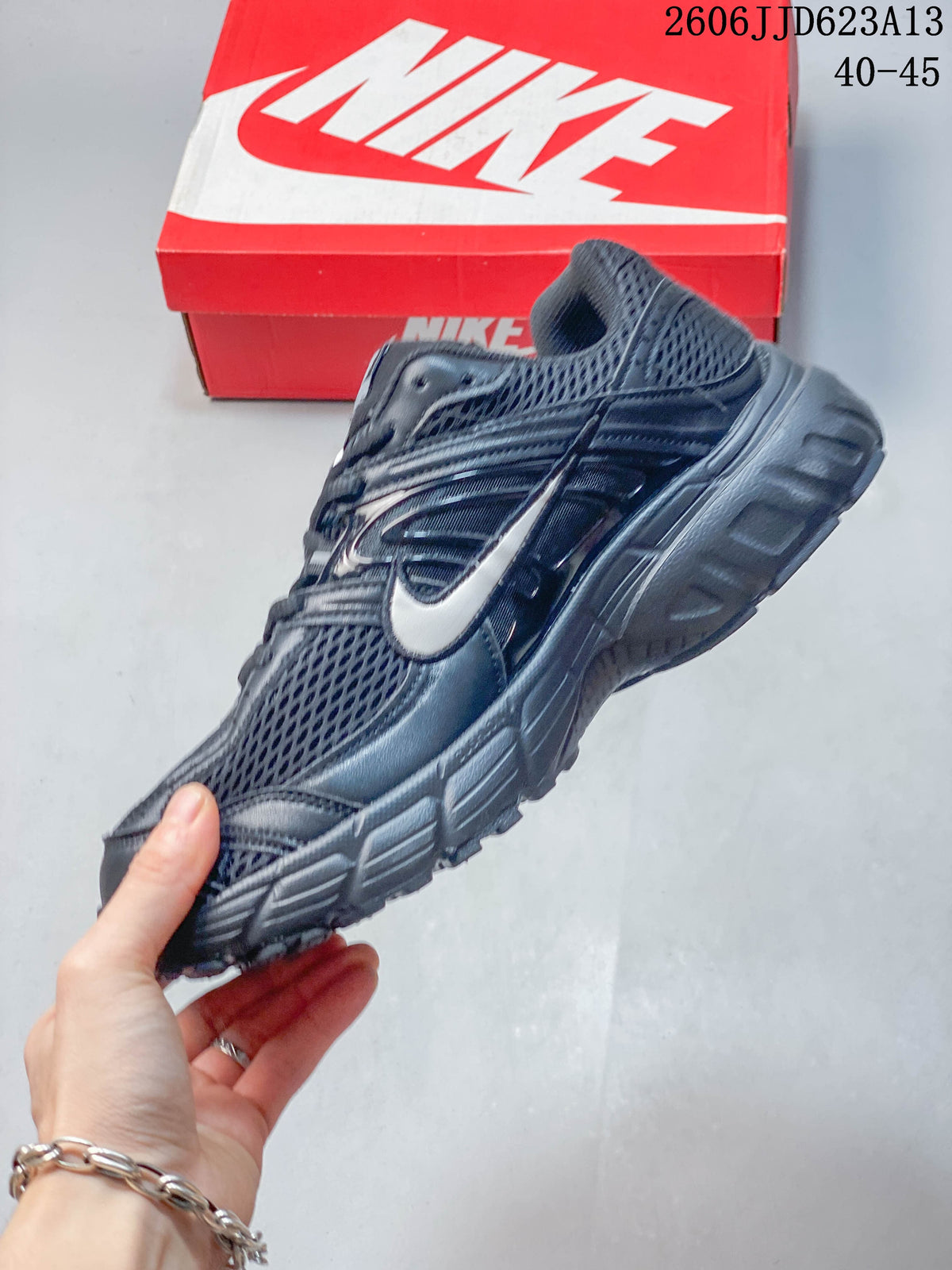 Side view of a dark grey Nike Air Max Moto 2K with silver-tone Swoosh and sculpted sole