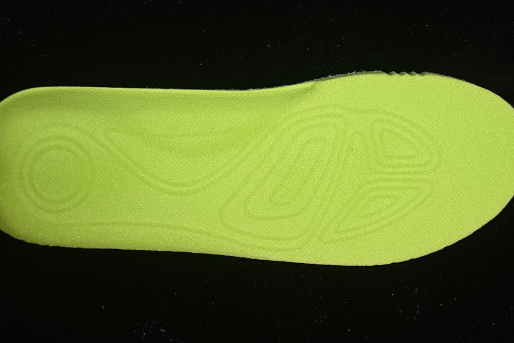 Close-up of the bright yellow-green shoe outsole