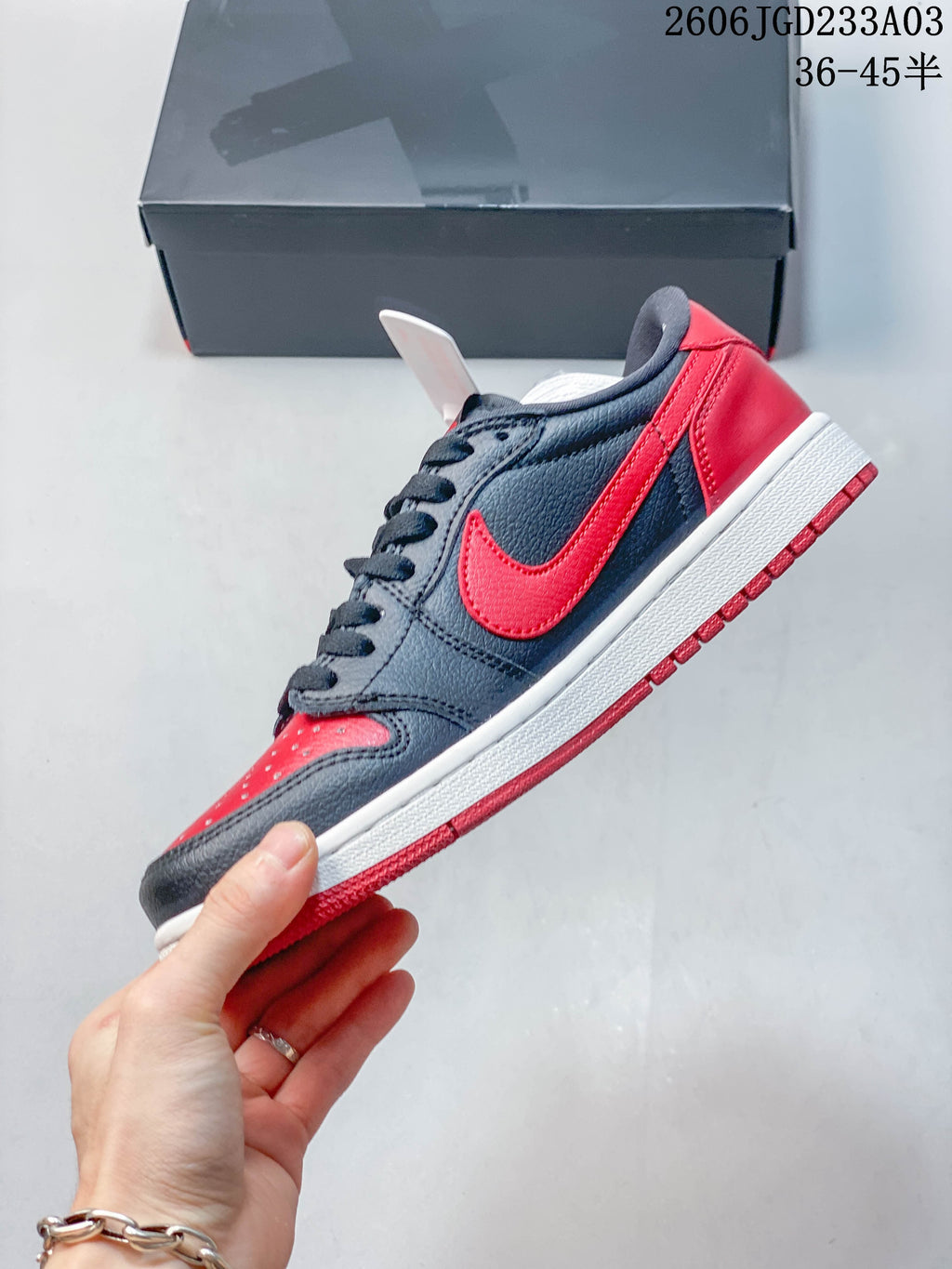 Side profile of a black and red low-top sneaker
