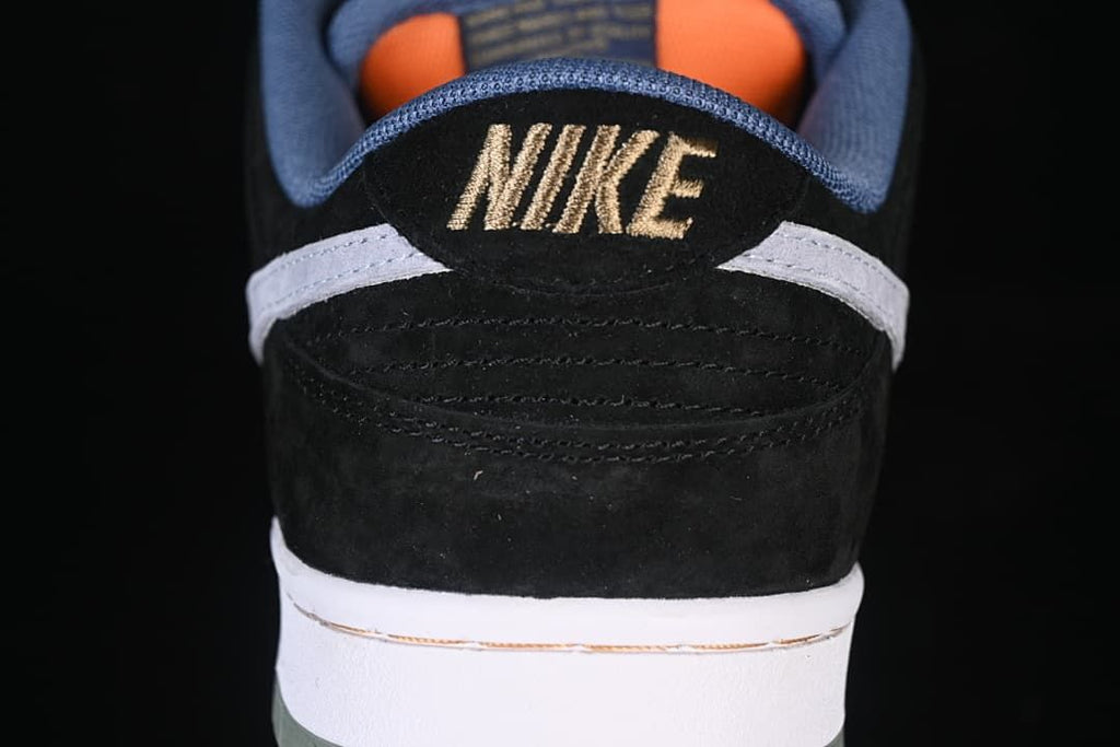 Rear view showing the black heel, grey detail, blue collar, and embroidered Nike branding
