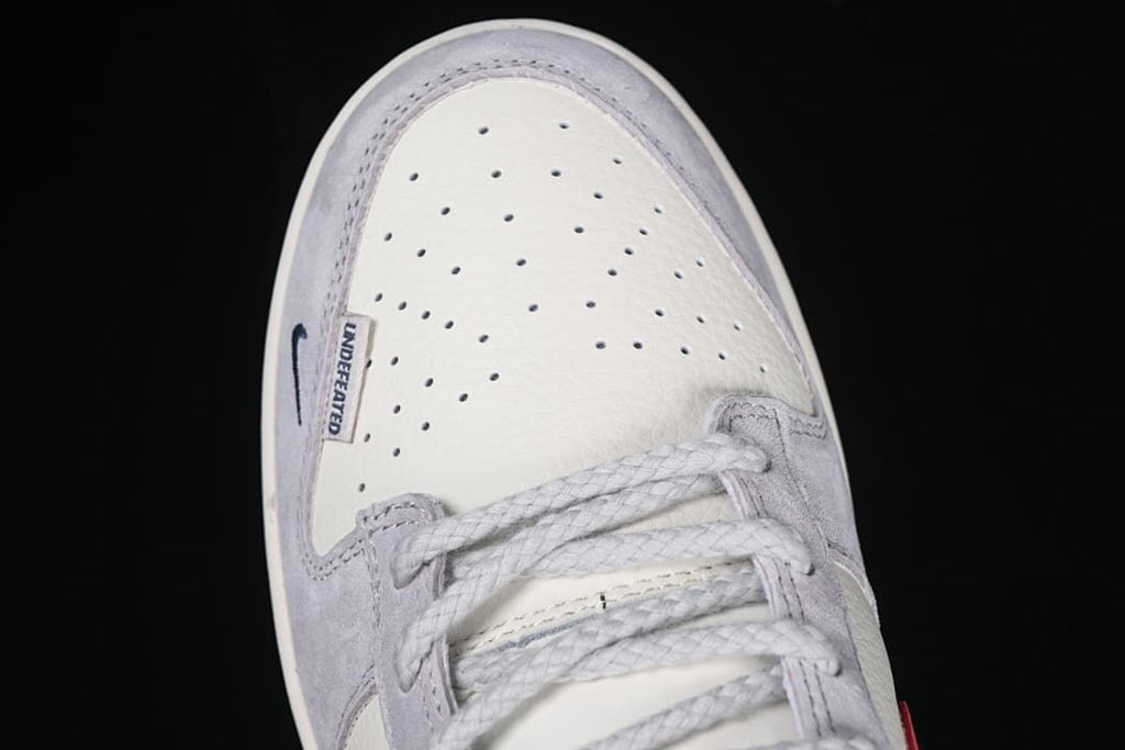 Top view of the perforated toe box, laces and Undefeated label.