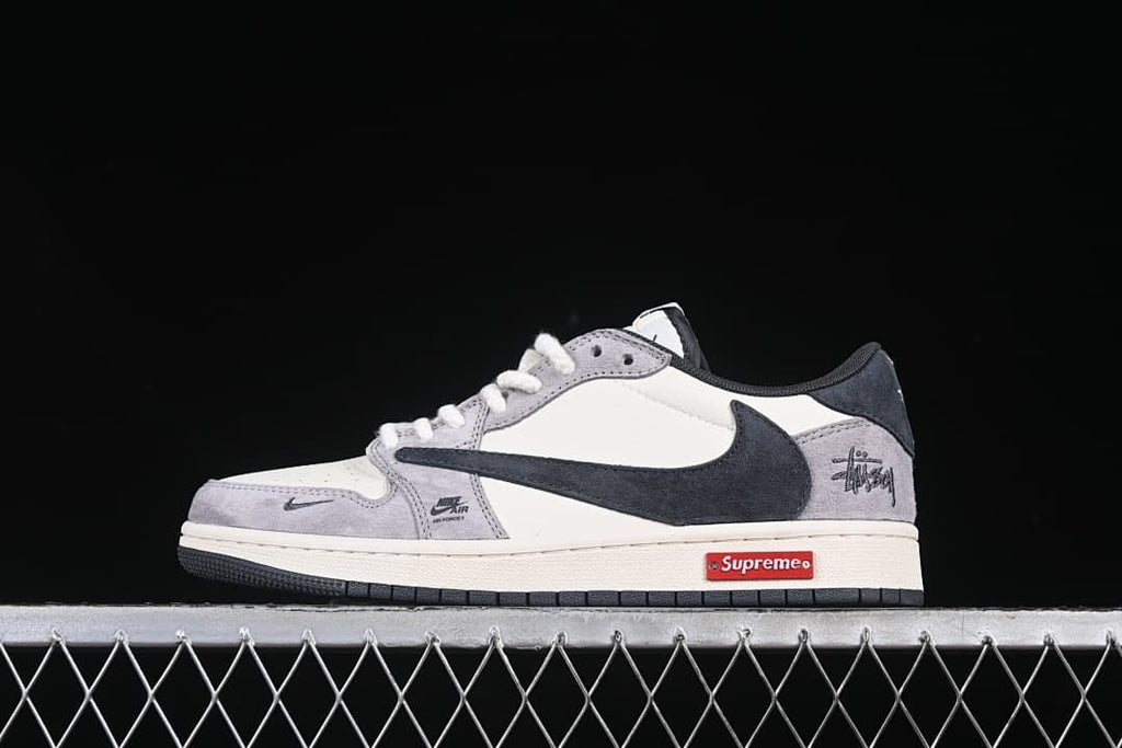 Low-top sneaker in gray, off-white and dark accents, shown in profile with a red rectangular midsole detail.