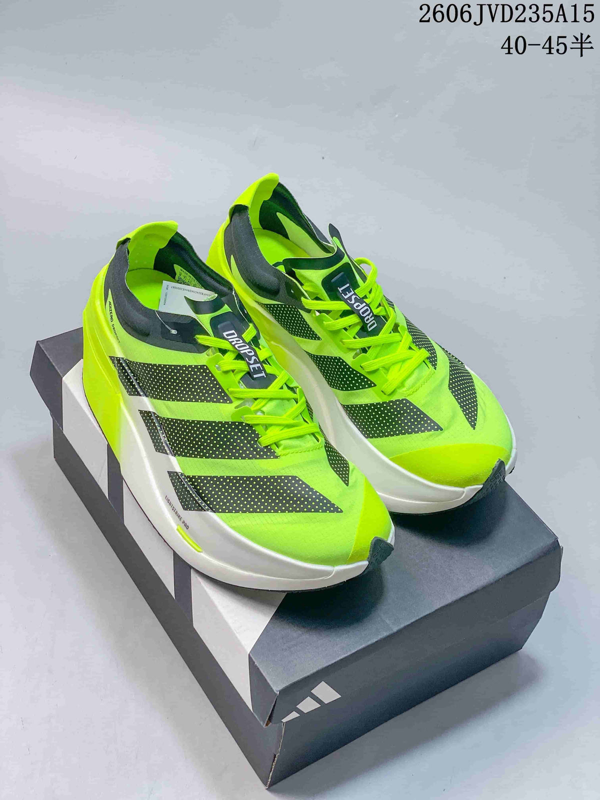 Pair of neon green Adidas Adizero Dropset shoes displayed on a shoebox