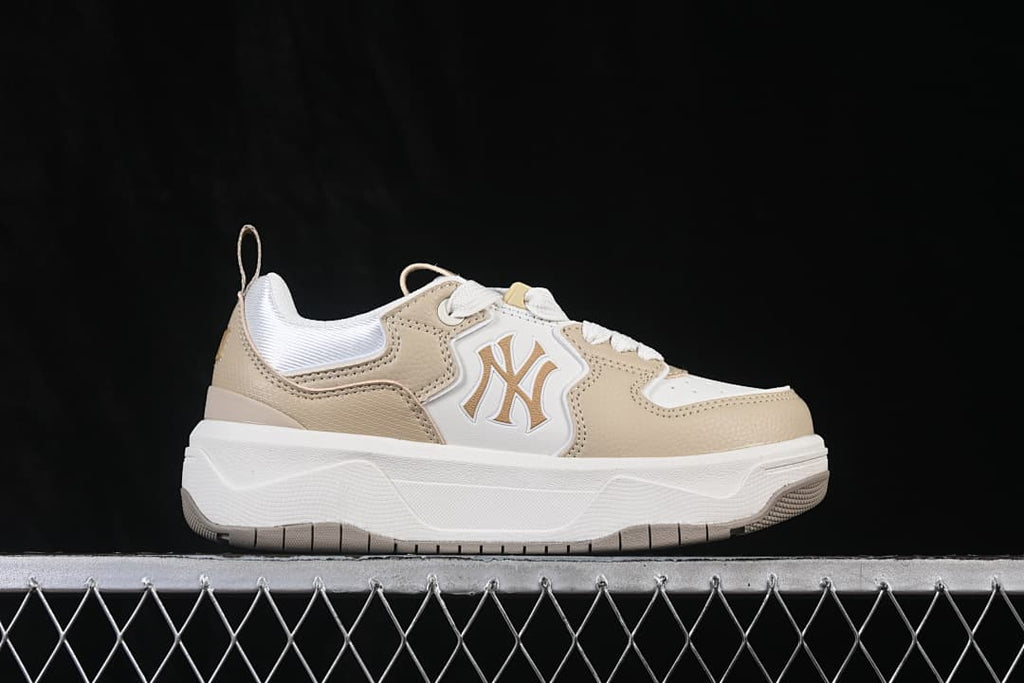 Side view of beige and white MLB Curve Liner sneakers with New York Yankees logo and chunky white sole