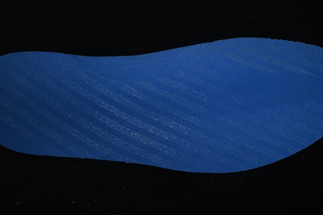 Close-up of a blue shoe component.