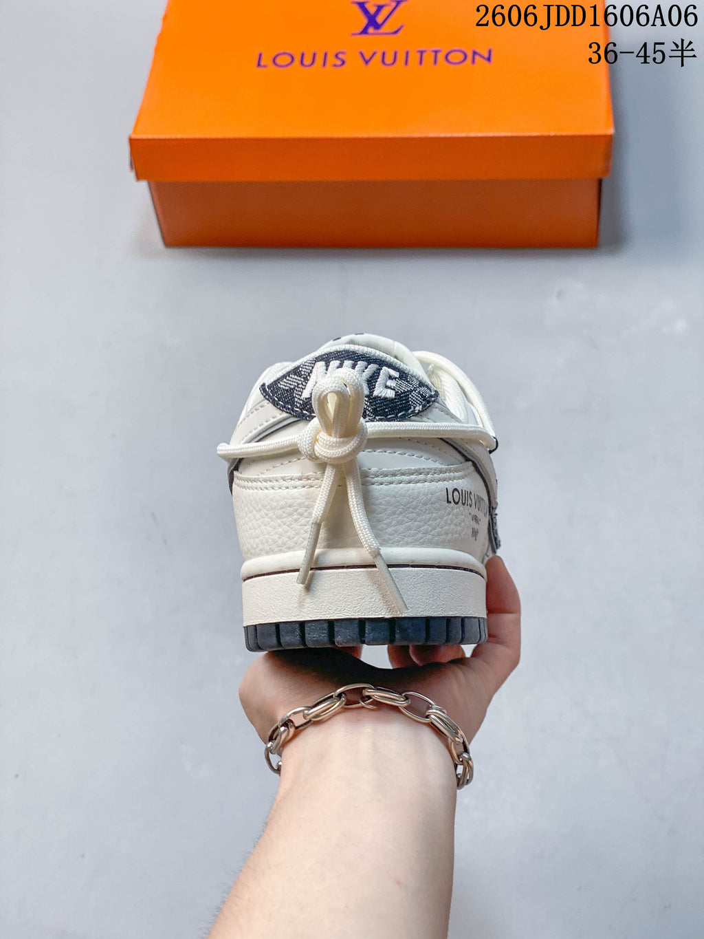 Rear view showing the heel, lacing detail, and orange shoe box.