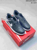 Dark navy Nike Big Low low-top sneakers with white Swooshes on a red shoe box.
