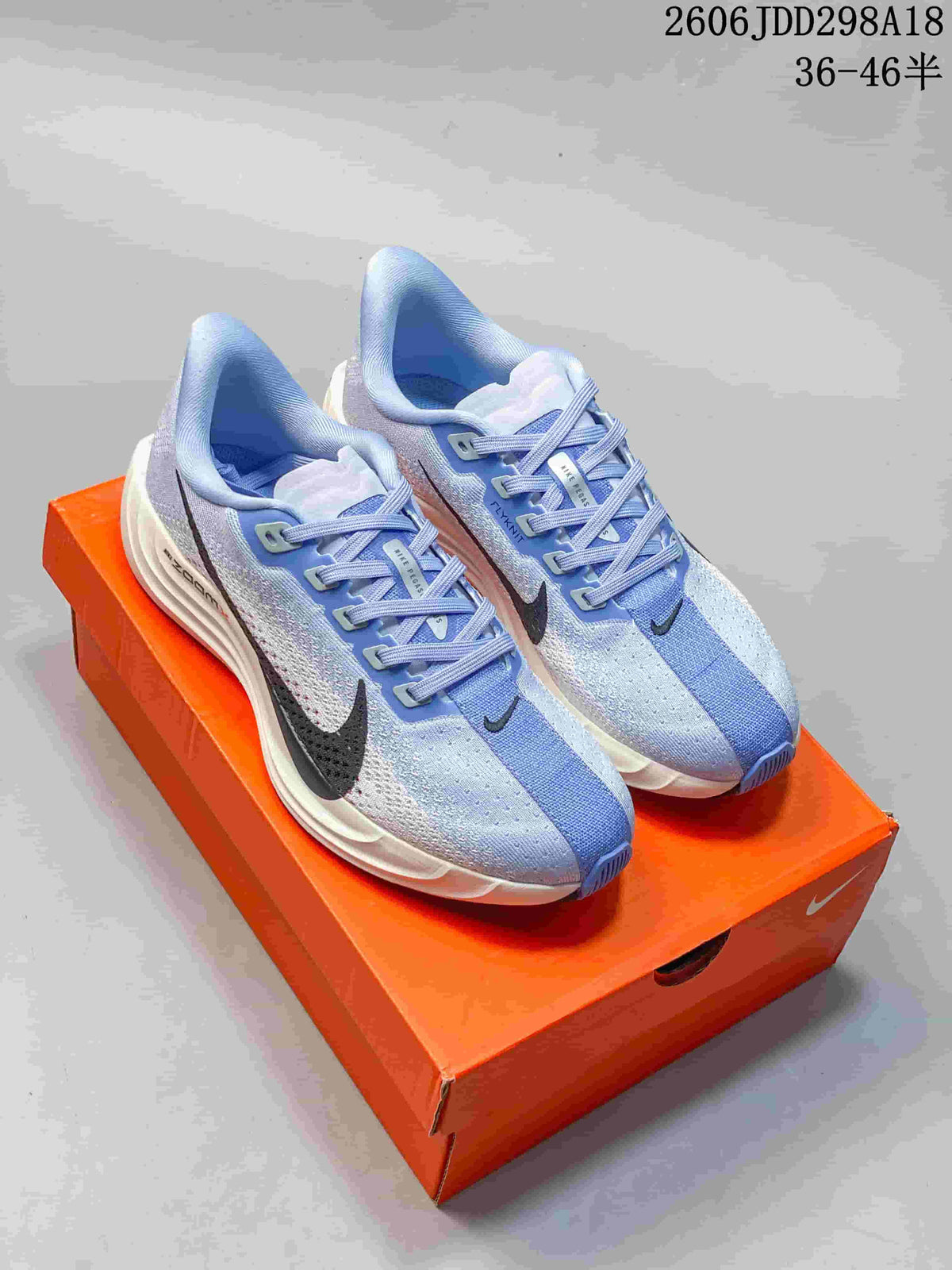 Pair of pale blue Nike Pegasus Plus running shoes with dark Swoosh details.