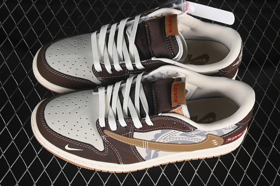 Overhead view of a pair of brown and white low-top sneakers with white laces, perforated toe boxes, gray patterned side panels, and branded tongue details.
