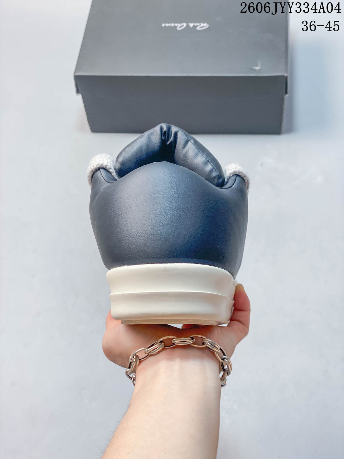 Rear view of a navy sneaker with an ivory sole