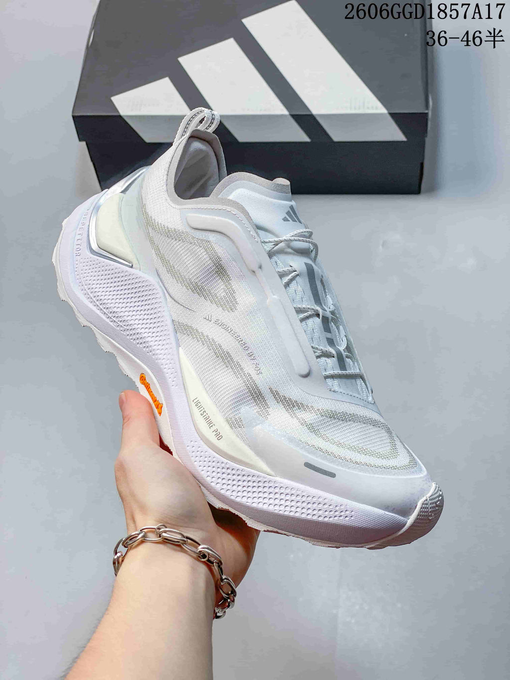 Angled side view of a white Adidas HOLO PEAK shoe