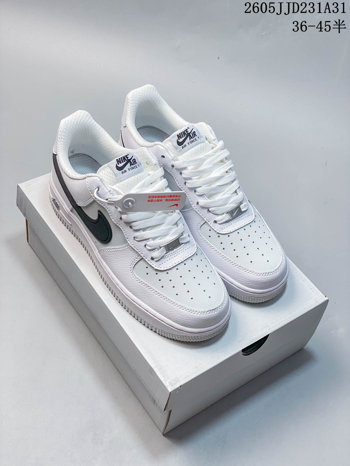 Pair of white Nike Air Force 1 Low sneakers with dark Swoosh details