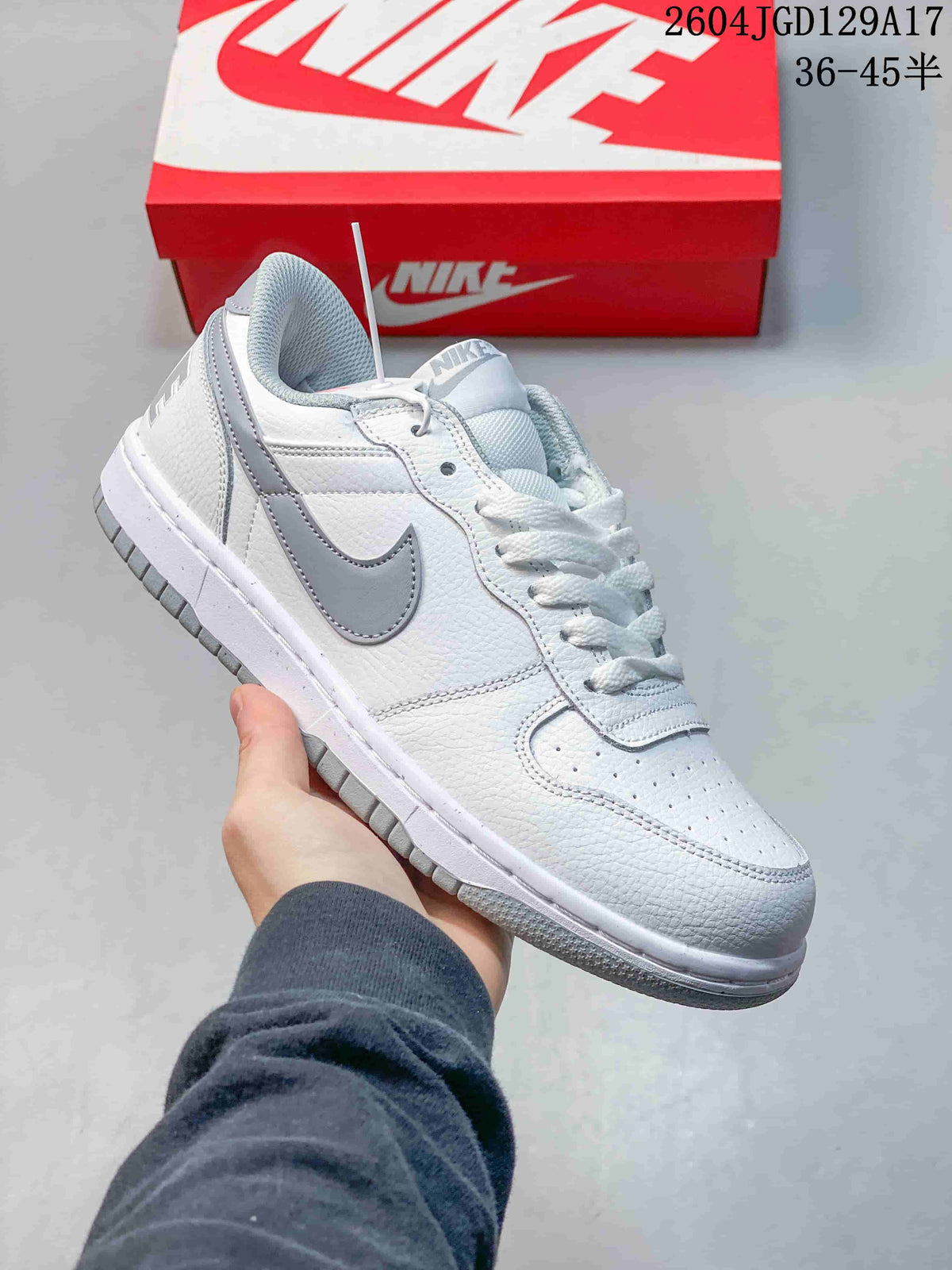 Close-up of a white Nike Big Low sneaker with a gray Swoosh and gray outsole accents.