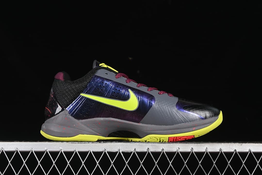 Side profile of the shoe with blue-purple panels and yellow outsole accents