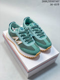 Teal lace-up sneakers with contrast panels and a sawtooth-style outsole on a shoebox