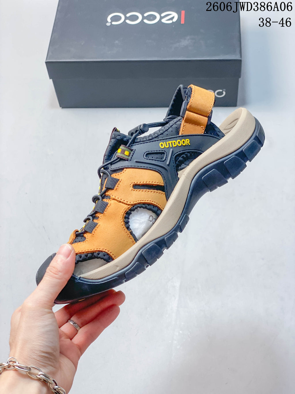 Side view of the orange and dark navy closed-toe outdoor sandal.