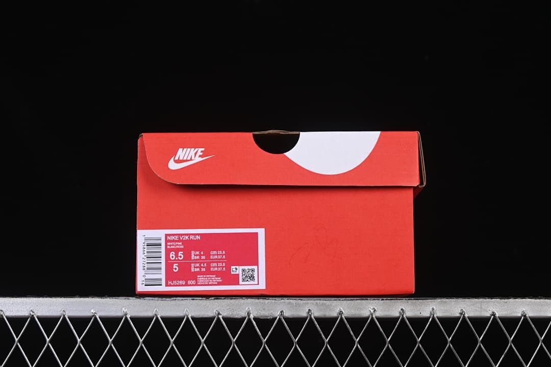 Red shoe box with a visible label identifying the Nike V2K Run and style code HJ5269-600.