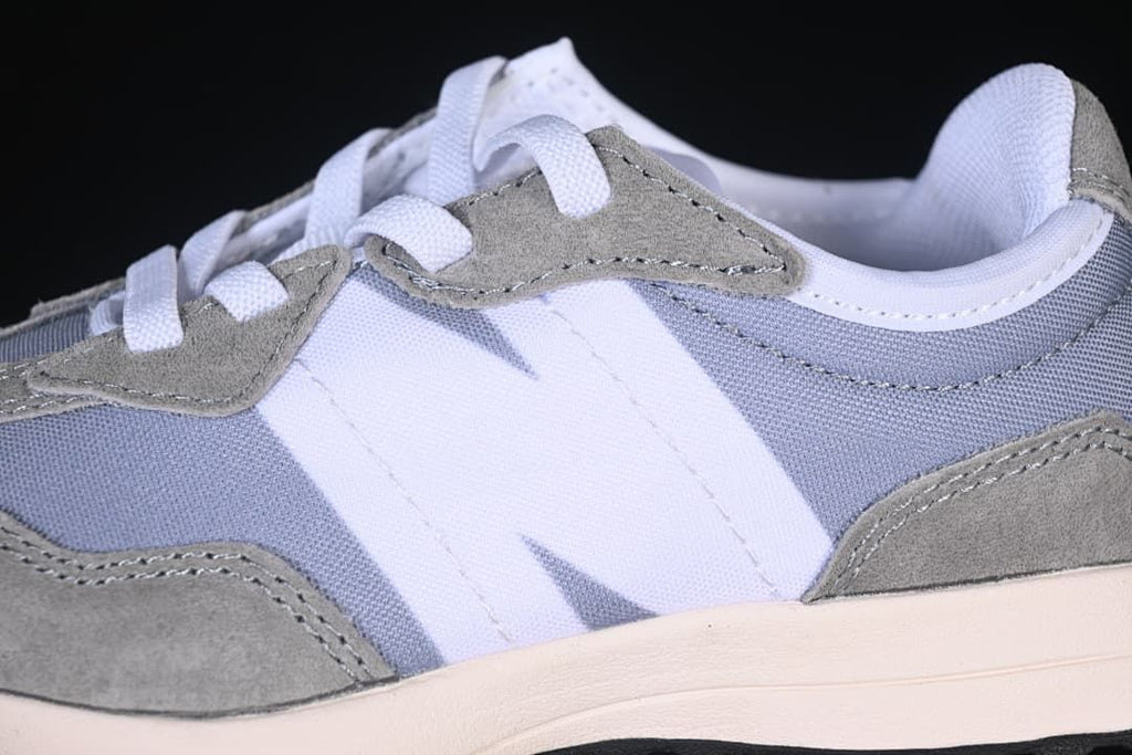 Close-up of the side logo, grey overlays, and white laces.