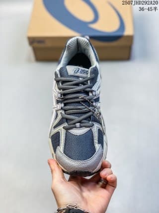 Front view of a navy and gray ASICS Gel-Kahana 8 sneaker showing the laces, mesh toe panel, and padded tongue.