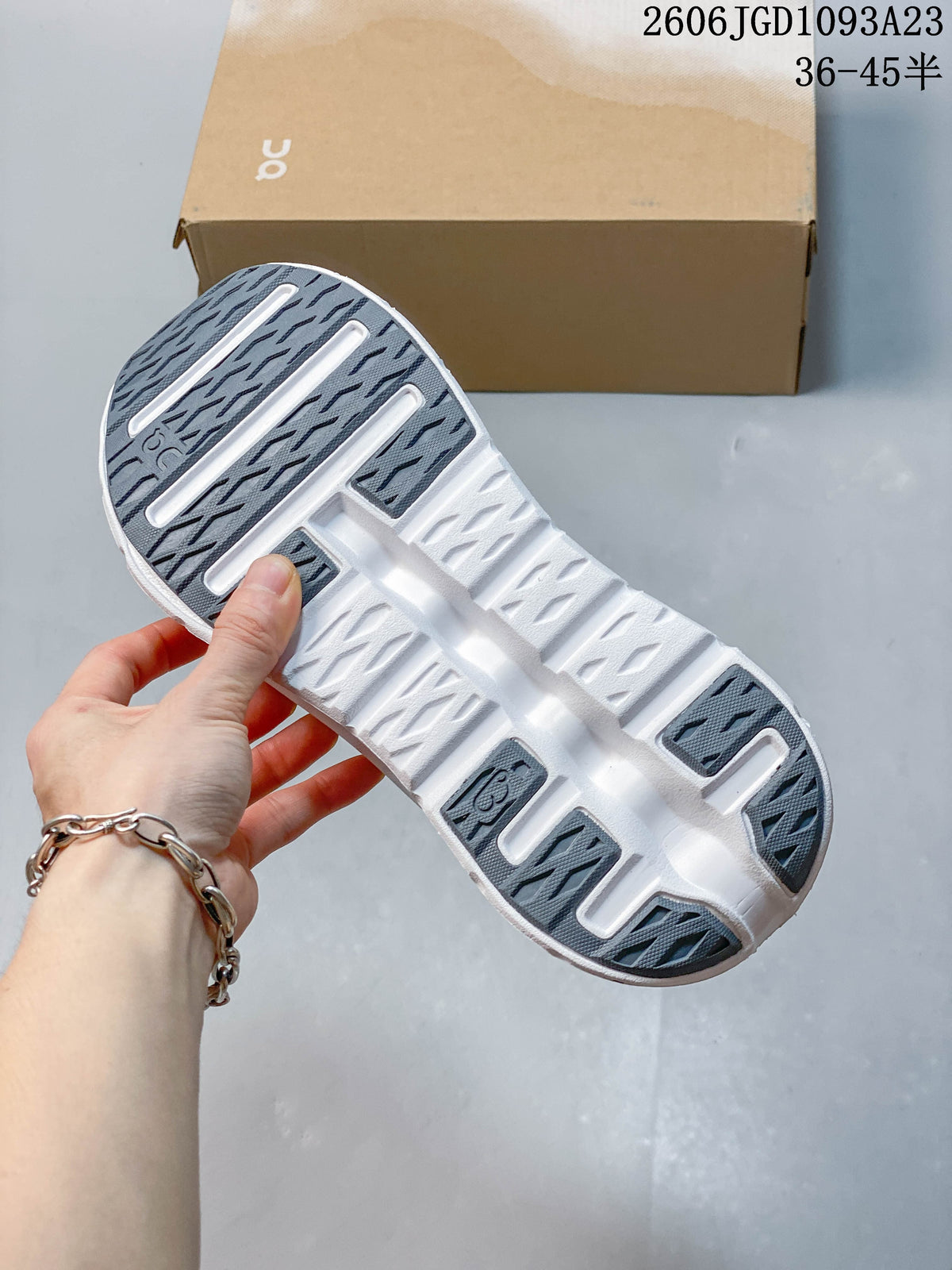 Underside of the sneaker showing a patterned outsole and white sole sections