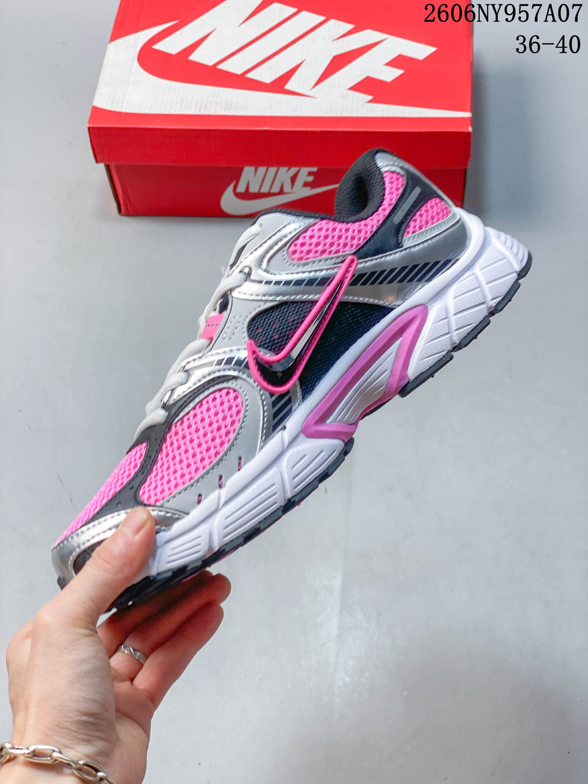 Side view of a Nike V5 RNR sneaker with silver overlays, pink mesh panels, and a white sole.