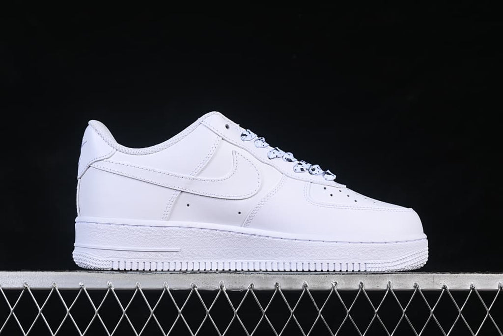 Side profile of a white low-top sneaker with a tonal side logo
