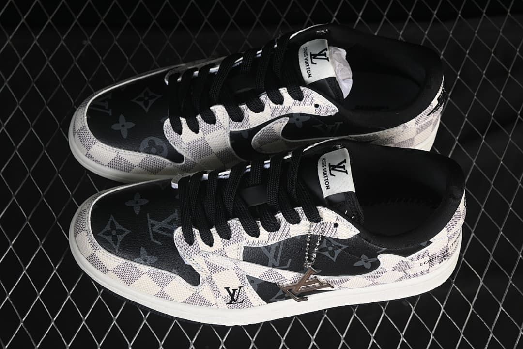 Pair of low-top sneakers shown from above, with gray patterned panels, dark toe sections, and black laces.
