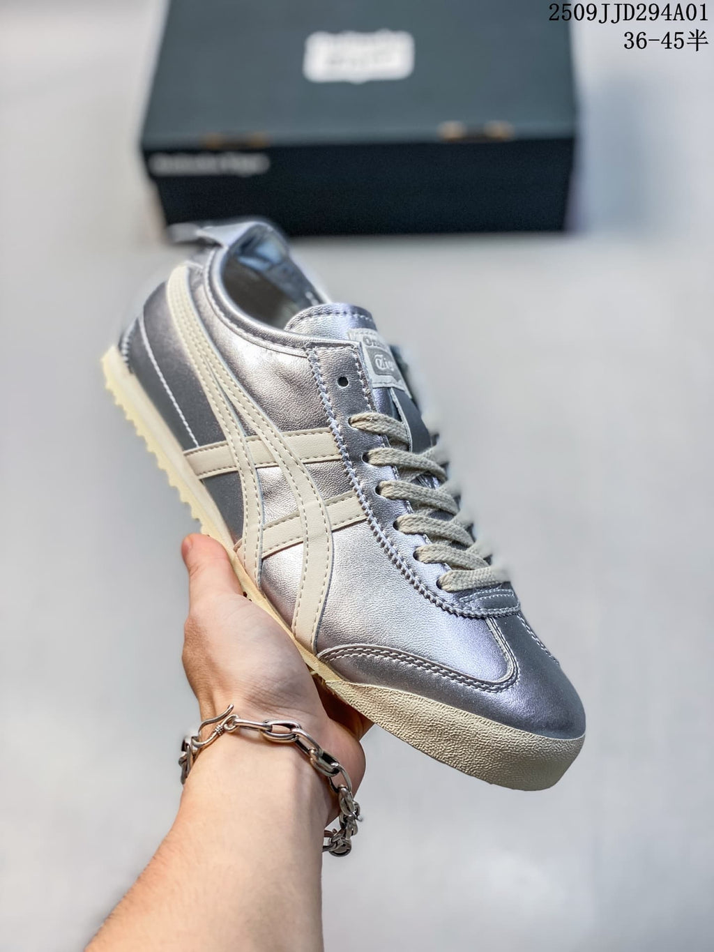 Silver metallic low-top sneaker with cream side stripes and a light textured outsole; size range text appears in the image.