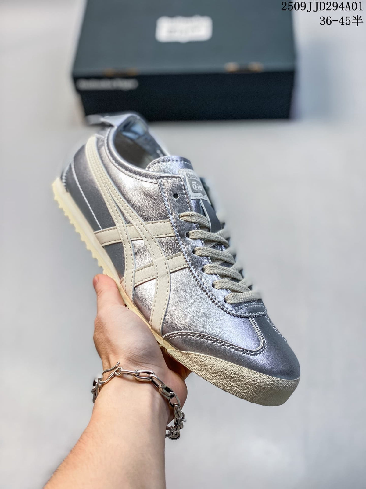 Silver metallic low-top sneaker with cream side stripes and a light textured outsole; size range text appears in the image.