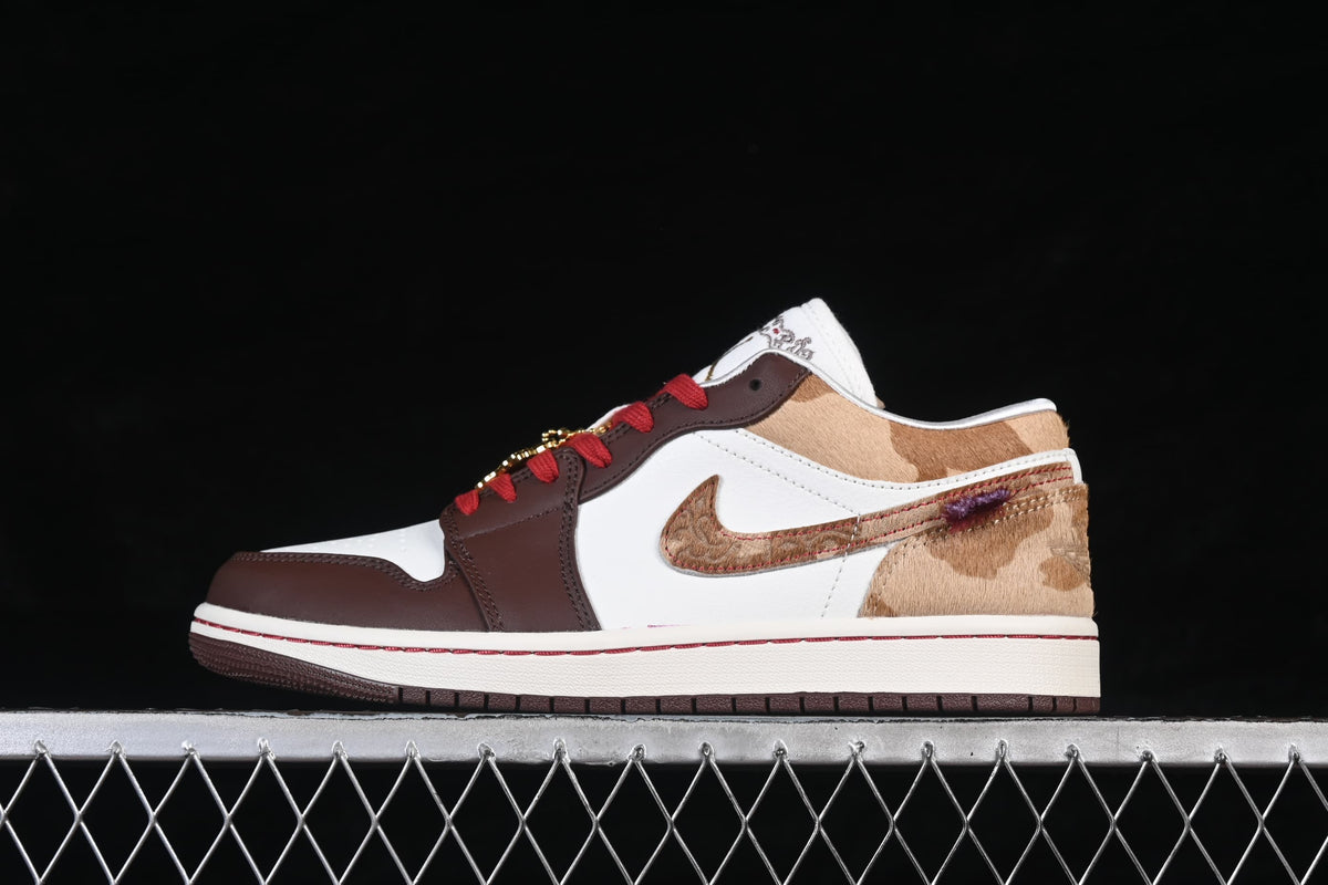 Side profile of the low-top sneaker with white, brown, tan, and red accents