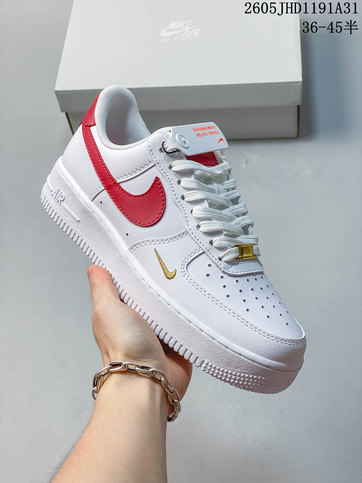 Angled view of the white sneaker with red Swoosh and heel accents